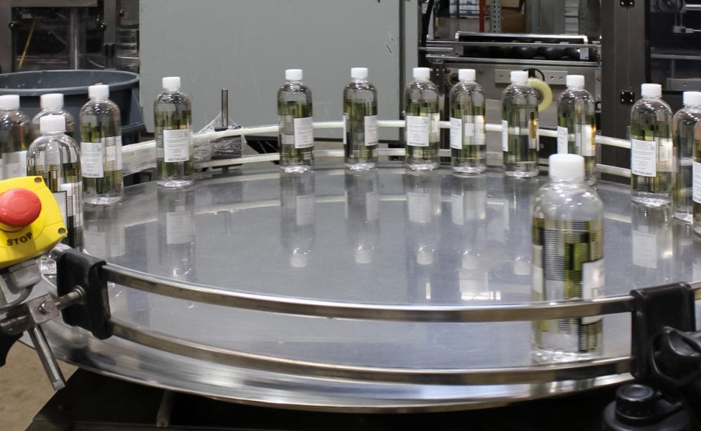 Finished custom-labeled water bottles on the production line
